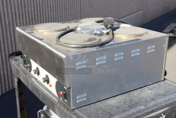 Brand new Nemco 6311-4-240 electric countertop hot plate with 4 solid burners, 240V, superficial denting visible.