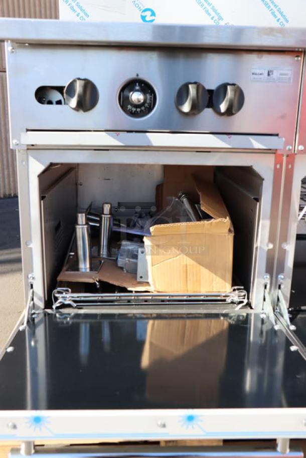 Wolf by Vulcan C60SS-10BN range, 10 burners, 2 ovens, 60". Dented back riser, missing parts. Serial: 482100801.