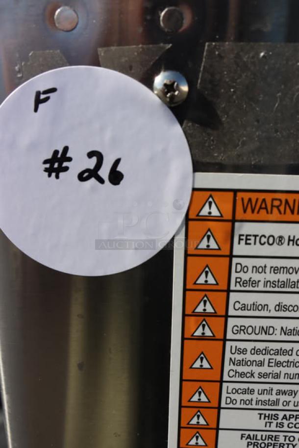 Fetco HWD-2110TOD hot water dispenser, new scratch-n-dent condition, serial 21101024252506, with warning label visible.