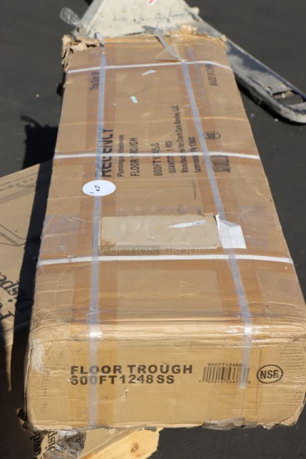 Brand new Regency FTG-1248 12"x48" stainless steel floor trough with grate, unopened. Damaged packaging visible.