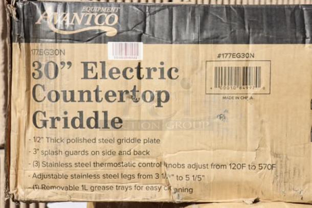 BRAND NEW Avantco EG30N 30" Electric Countertop Griddle in damaged packaging. Features steel plate, adjustable legs, and thermostat controls.