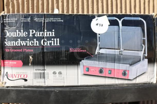 Brand new Avantco PG400 Dual Panini Grill, grooved plates, 19 5/8" x 9 1/8" surface, 120V, 3500W, original packaging damaged.