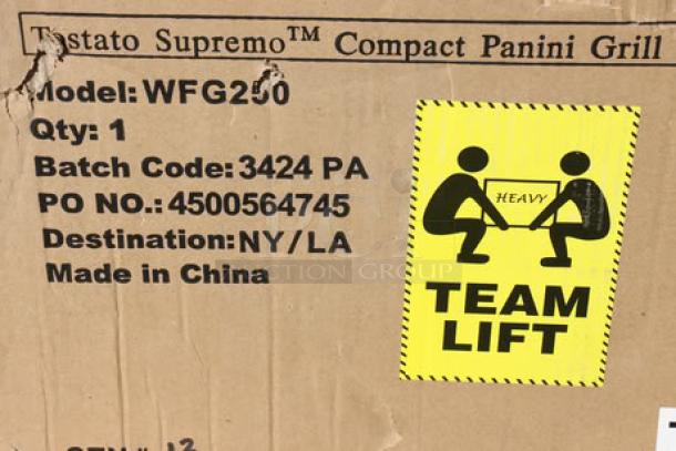 Brand new Waring WFG250 Panini Grill box with model details and "Team Lift" warning label.