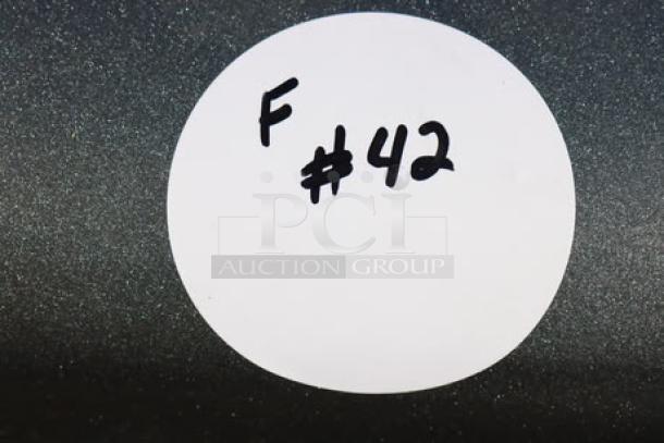 White sticker labeled "F #42" on a gray background, possibly indicating item inventory or lot number.