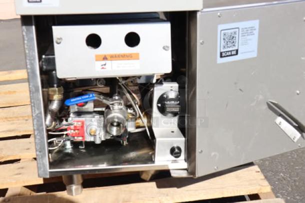 Cooking Performance Group FCPG15 natural gas fryer, 26,500 BTU, open access panel, warning label visible, good condition.