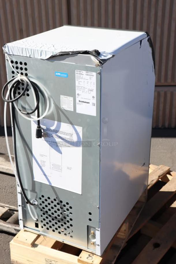 Scotsman CU0715MA-1 15" ice machine, 80 lb. capacity, air cooled, 115v, dented back corner, model details visible.