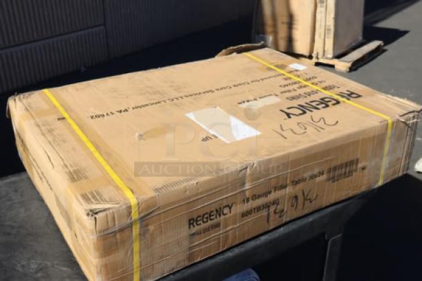 Regency WT-243038-S stainless steel table in original damaged packaging, possible scratches or dents, missing small parts.