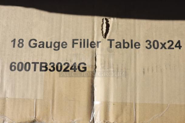 Cardboard packaging for Regency WT-243038-S 18-gauge filler table, 30"x24", model 600TB3024G, with visible tears.