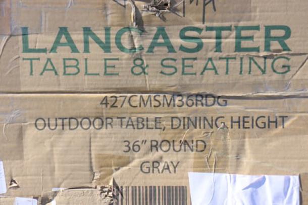 Lancaster Table 36" round outdoor table, model 427CMSM36RDG, gray, new with damaged packaging, potential scratches/dents.