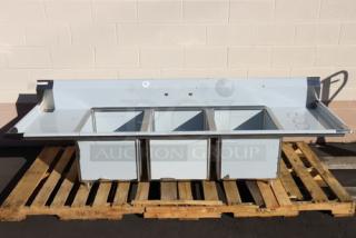 Brand new Regency 94" stainless steel three-compartment sink with galvanized legs and two drainboards. Model 600S31824218. Minor scratches/dents.