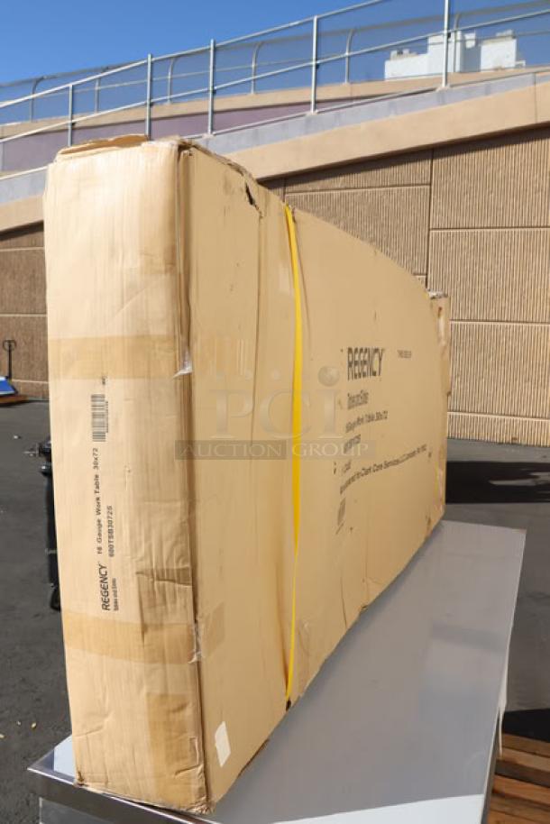 Brand new Regency WT-723038-S-16 work table in original packaging; 30"x72", 16-gauge stainless steel, 4" backsplash, undershelf.