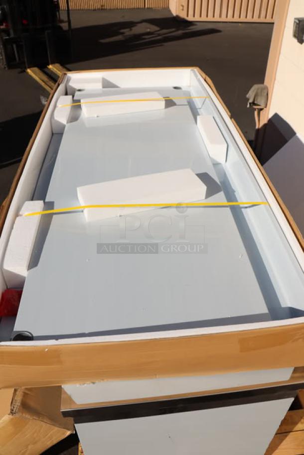 Brand new Regency WT-723038-S-16 work table, 30"x72", 16-gauge stainless steel, with 4" backsplash and undershelf, in packaging.