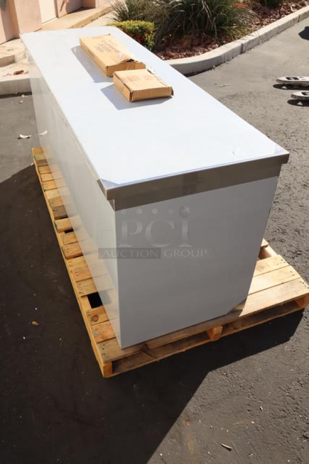 Brand new Regency C-2472-316 stainless steel table, enclosed base, sliding doors, on pallet. Model label visible.