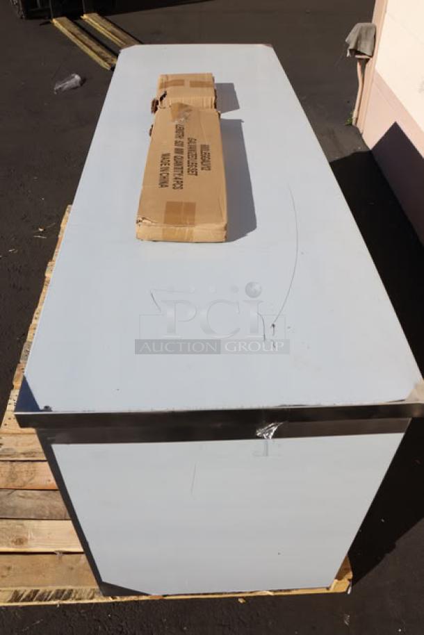 Regency C-2472-316 24"x72" stainless steel table with sliding doors, adjustable midshelf. New scratch-and-dent condition.