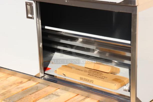 Brand new Regency C-2472-316 stainless steel table with sliding doors, adjustable midshelf, and enclosed base.