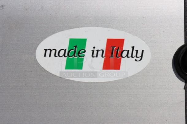 Oval sticker reading "made in Italy" with Italian flag design on a metallic surface.