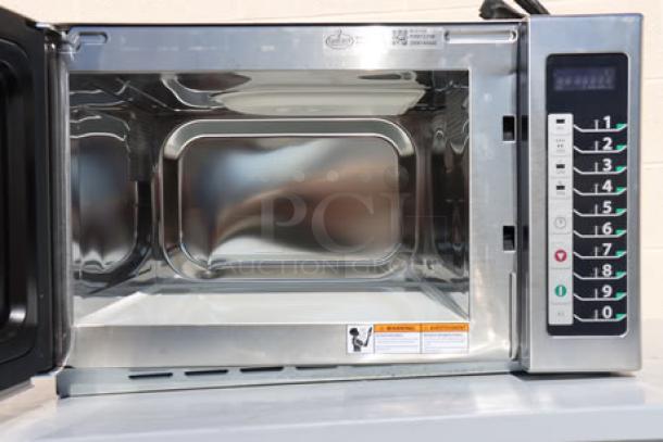 BRAND NEW Amana RCS10TS stackable commercial microwave, 1000W, with push button controls, minor scratches, model visible.