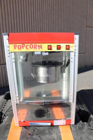 Carnival King PM50NR Royalty Series 12 oz. red commercial popcorn machine in good condition. Visible "POPCORN" label.