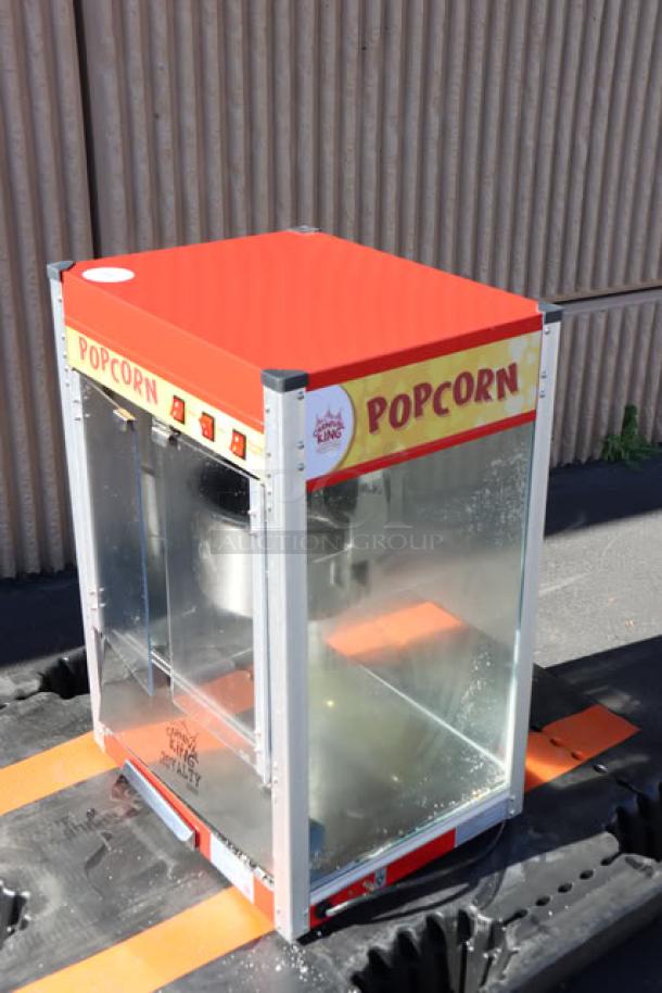 Carnival King PM50NR Royalty Series 12 oz. red commercial popcorn machine, transparent panels, "Popcorn" label, 120V.