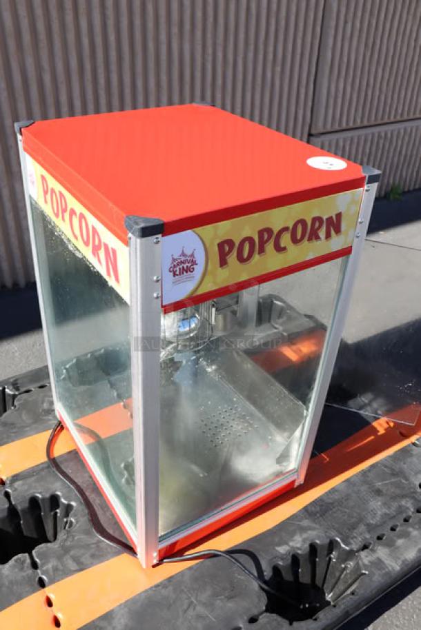 Carnival King PM50NR 12 oz. red popcorn machine in good condition, features clear panels and bold "POPCORN" branding. Model: PMS0NR.
