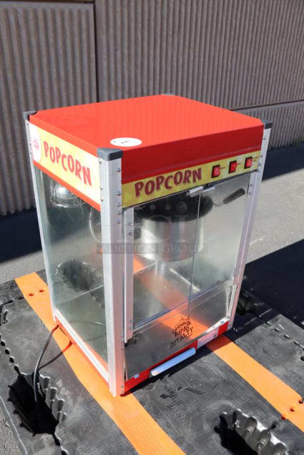 Carnival King PM50NR Royalty Series 12 oz. red popcorn machine, commercial grade, excellent condition, visible controls.
