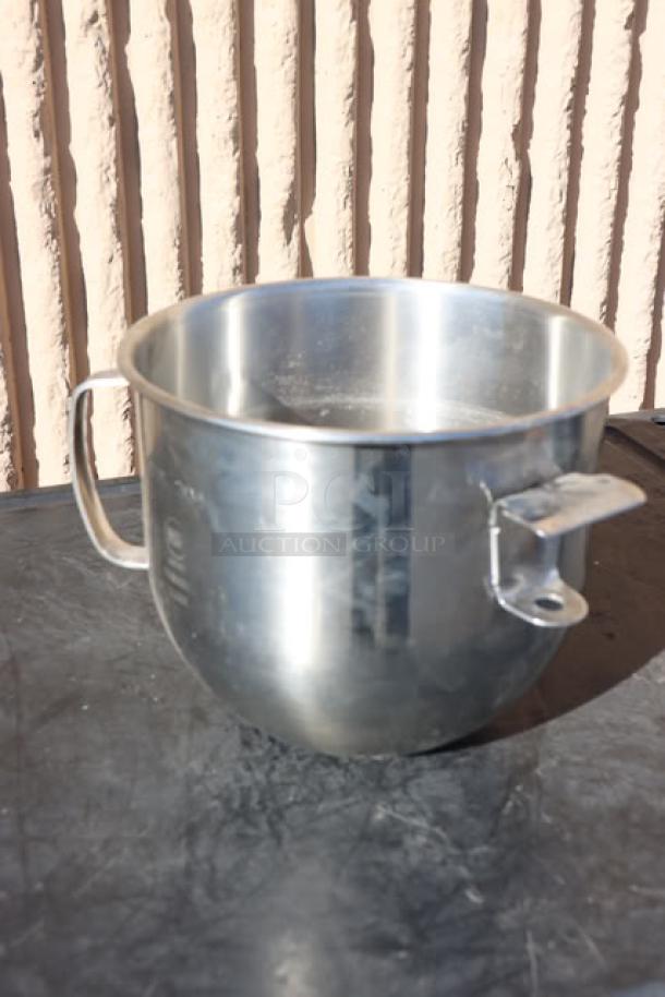 8 qt. stainless steel mixer bowl with handles, part of a massive mixed auction lot. Used condition, minor wear visible.