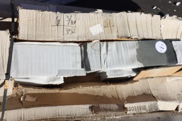Mixed lot of stainless steel and epoxy items in original packaging, showing some wear. Includes work table, wire shelf, table top, overshelf, table frame.