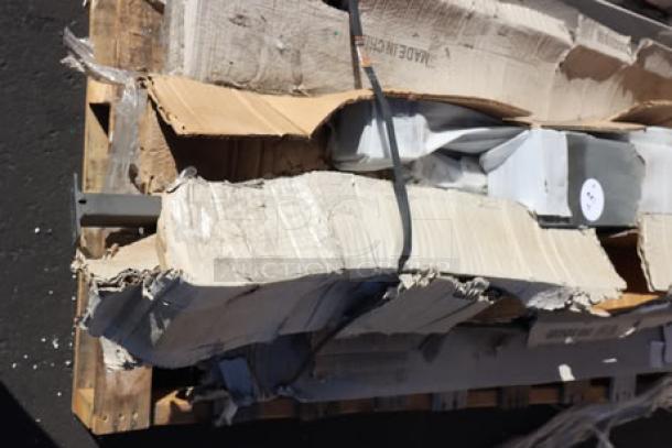 Mixed lot of new items including Steelton work table, Regency wire shelf, table top, overshelf, and table frame. Original packaging visible.