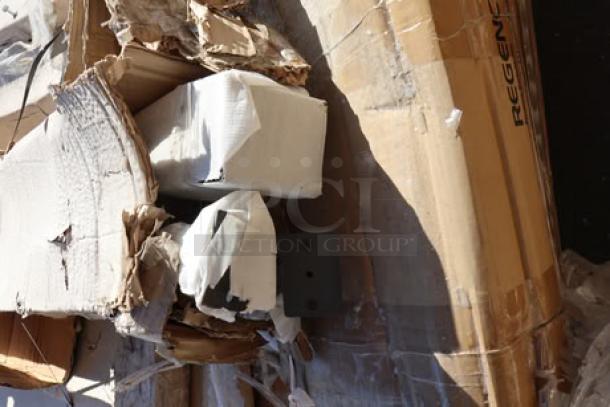 Mixed lot of kitchen equipment in original packaging with visible Regency branding; includes a steel table, wire shelf, and table frame.