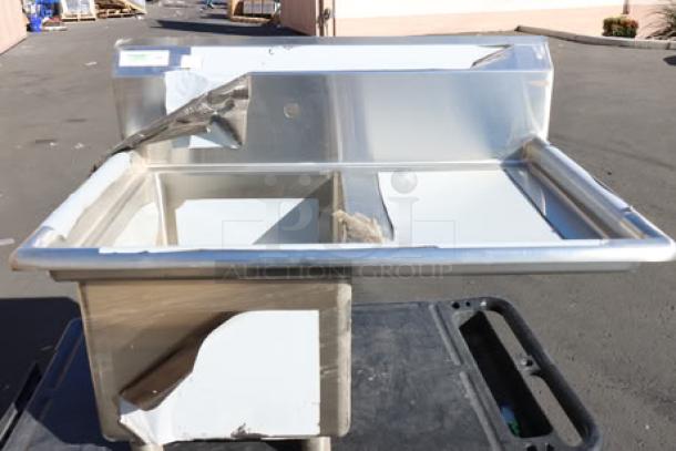 Regency stainless steel commercial sink with right drainboard, visible scratch-and-dent condition, stainless steel construction.