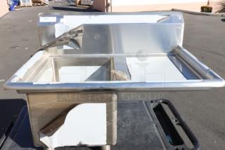 Regency stainless steel commercial sink with right drainboard, visible scratch-and-dent condition, stainless steel construction.