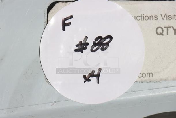 White circular label with handwritten "F #88 x4" on a metallic surface, partly covering printed text.