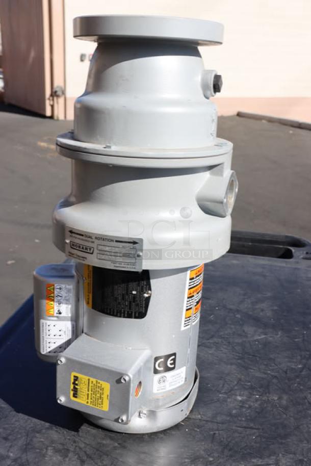 Hobart FD4/50-3 commercial garbage disposer, 1/2 hp, features dual rotation, identifiable by warning and CE labels.