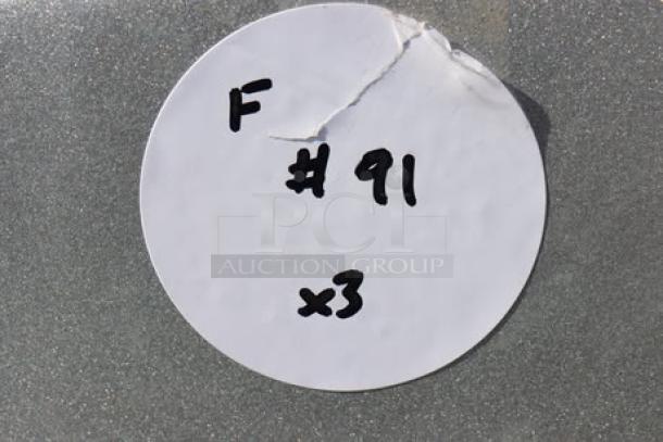 A white circular sticker with "F #91 x3" handwritten, partially torn at the top.