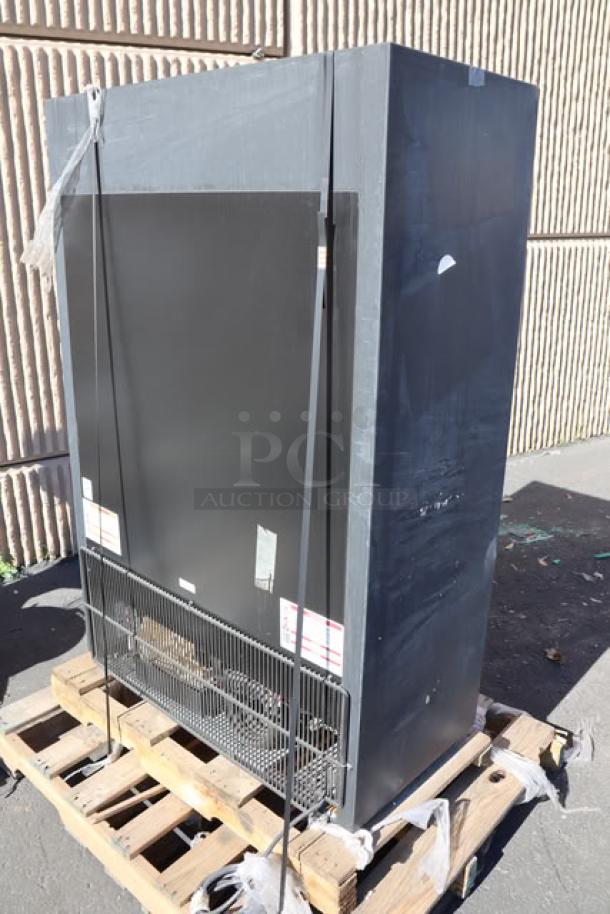 Brand new True GDM-33SSL-56-HC-LD black convenience store refrigerator with broken outer glass pane, on pallet.