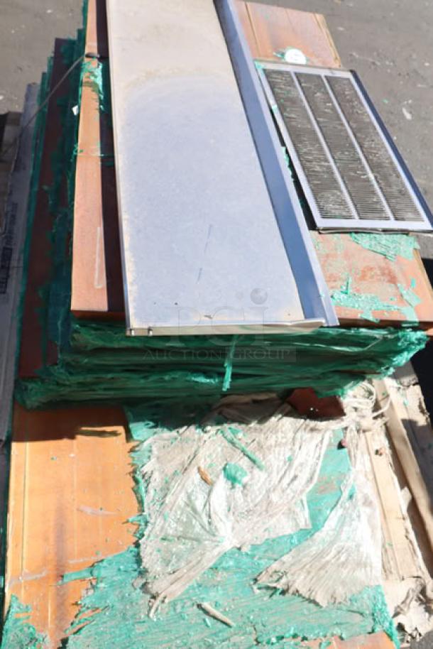 Stack of 11 wood table tops, top piece with visible cracks, wrapped in green plastic. Auction lot: 11x your bid.