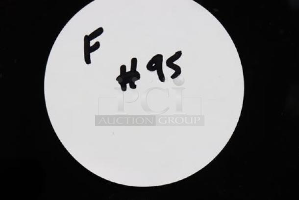 A handwritten label reading "F #95" on a white circular sticker against a black background.