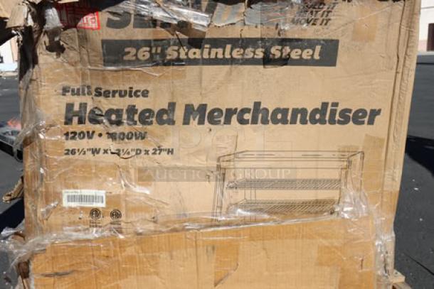 Cardboard box labeled "Full Service Heated Merchandiser 120V, 1800W, 26" Stainless Steel" with visible damage.