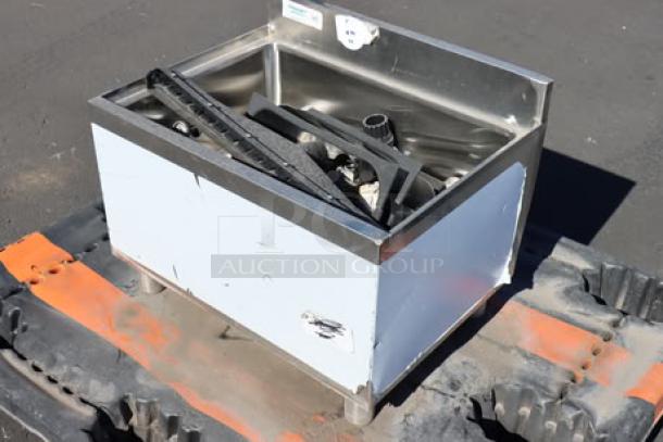 Underbar ice bin with post-mix cold plate and bottle holders, showing surface wear and scratches, out of packaging.