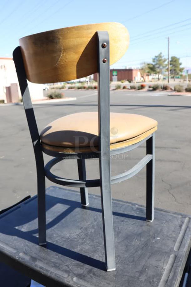 Lancaster Boomerang Chair with padded vinyl seat, wooden back, and metal frame. New, minor scratches, sturdy construction.