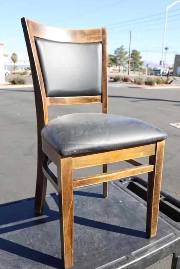 Lancaster Sofia Vintage Finish Wood Chair with black vinyl seat, excellent condition, outdoor setting background.