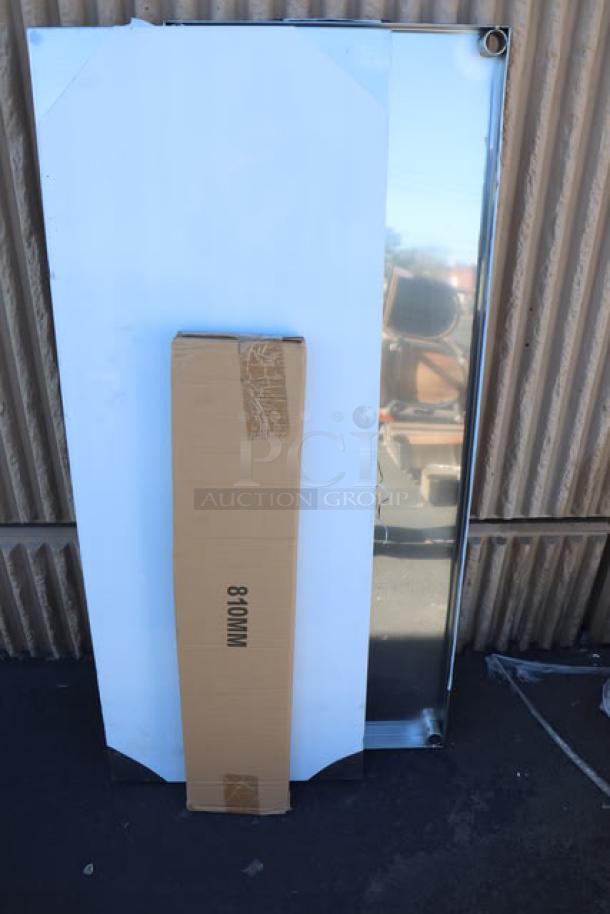 Cardboard packaging and stainless steel panels, possibly part of a 7-piece auction lot including chairs and utility sink.
