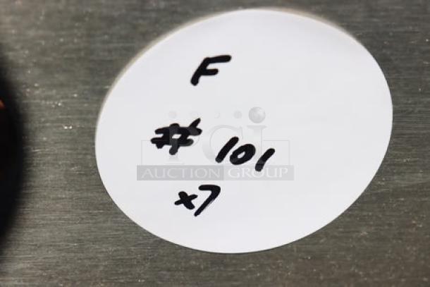 Round sticker on metal surface labeled "F #101 x7."
