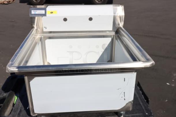 Brand new Regency wall-mounted hand sink, 48"x17.5", for two single-inlet faucets, shown with dual mounting holes.