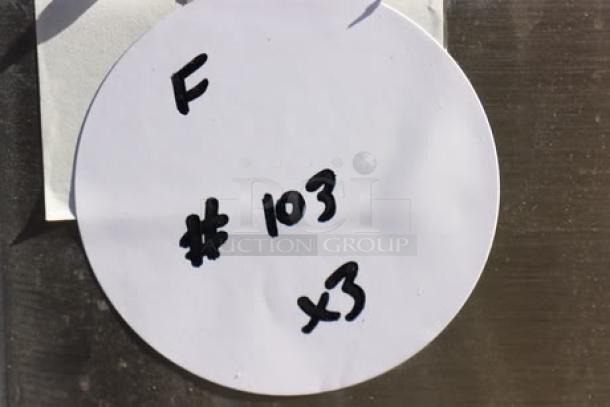 Round tag with "F #103 x3" handwritten, indicating auction lot details for three stainless steel sinks.