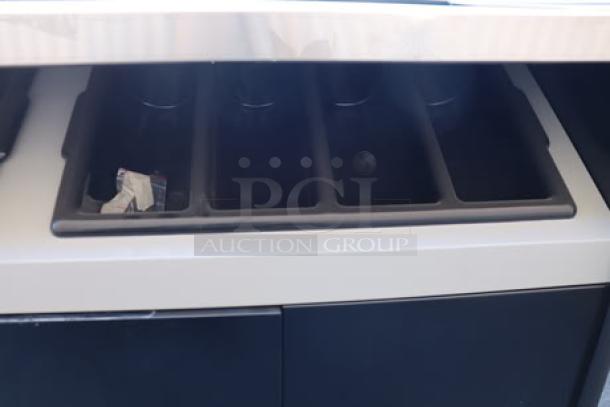 All State Manufacturing coffee stand OCS490, 49"x23.25"x34", with two condiment trays. Top panel dented and scratched.