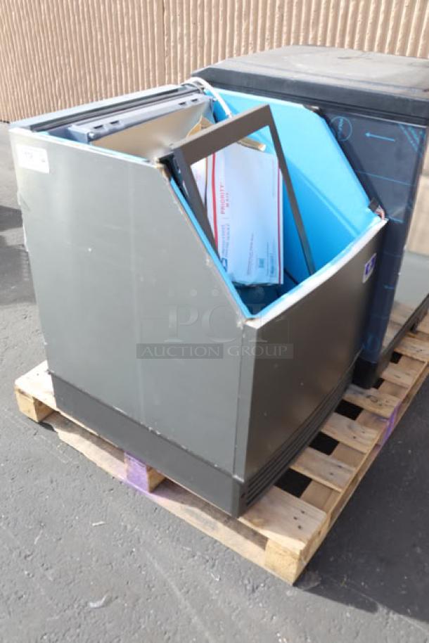 BRAND NEW Manitowoc UDF0240W Ice Machine on pallet; water-cooled, undercounter, 90 lb bin capacity, 115V, with shipping materials.