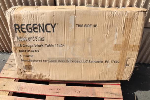 Box containing Regency 18" x 24" 18-Gauge Stainless Steel Work Table with 4" Backsplash; brand new, unopened.