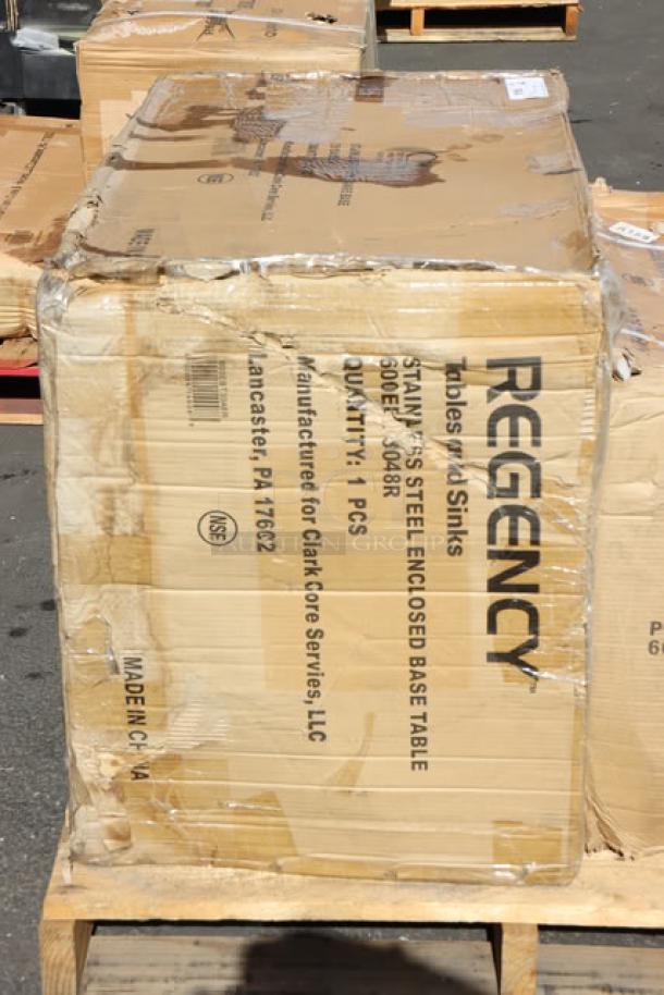 Regency stainless steel enclosed base table in damaged packaging. Includes sliding door, drawers, and ice bin with bottle holders.