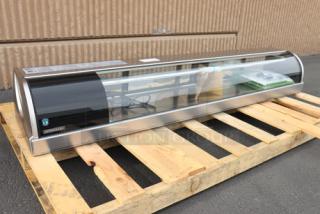 Brand new Hoshizaki HNC-180BA-L-SLH 71" curved glass refrigerated sushi display case with left side compressor on a pallet.